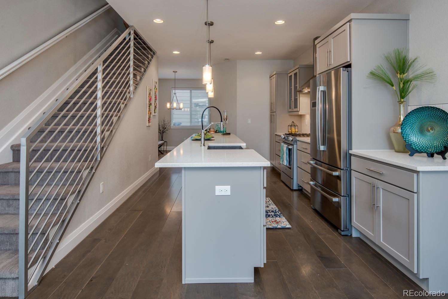 1571 Wolff Street Denver, CO 80204 - Photo 5 of 27 a kitchen with stainless steel appliances granite countertop a refrigerator a sink and a stove