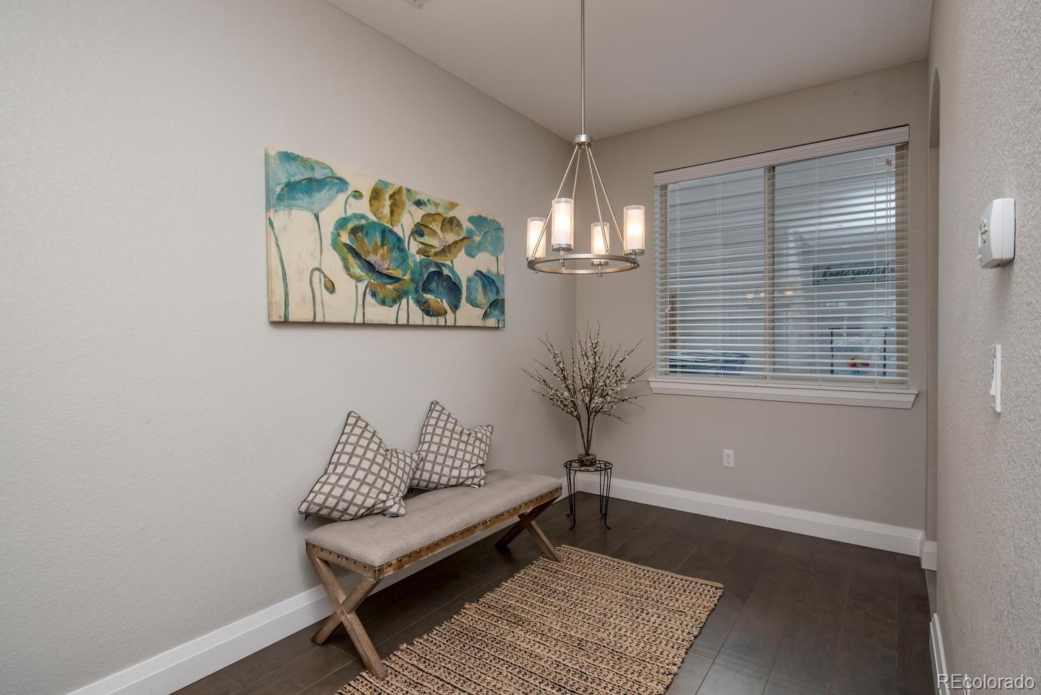 1571 Wolff Street Denver, CO 80204 - Photo 9 of 27 a living room with furniture and a chandelier