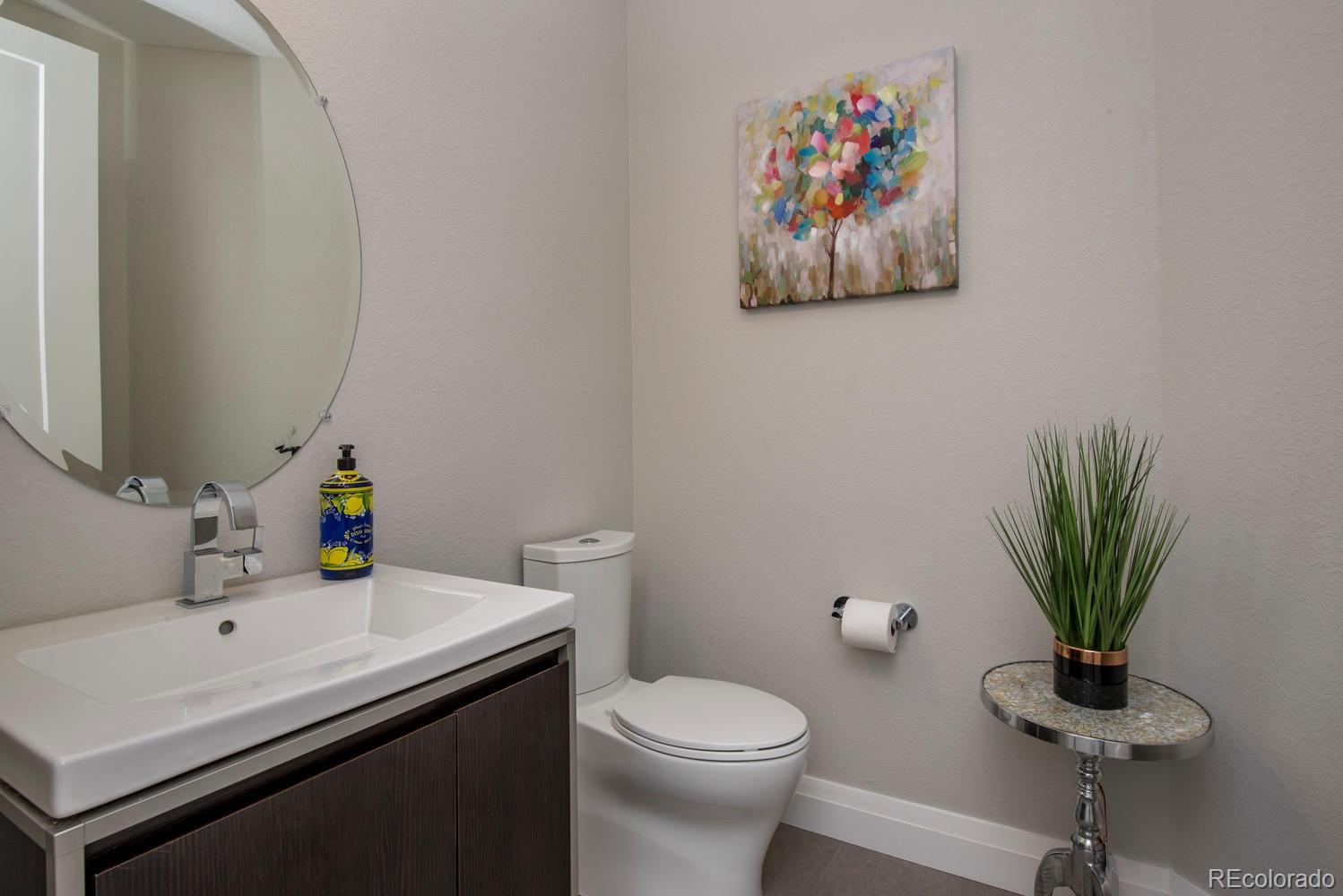 1571 Wolff Street Denver, CO 80204 - Photo 10 of 27 a bathroom with a toilet sink and mirror