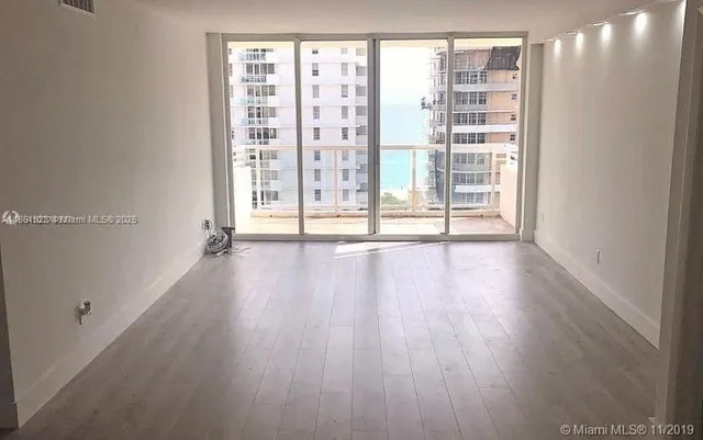a bedroom with bed and flat screen tv