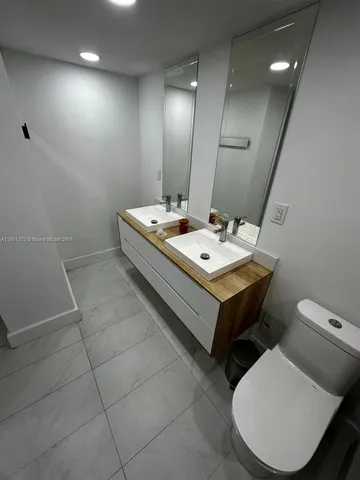 a very nice looking rest room with a chair