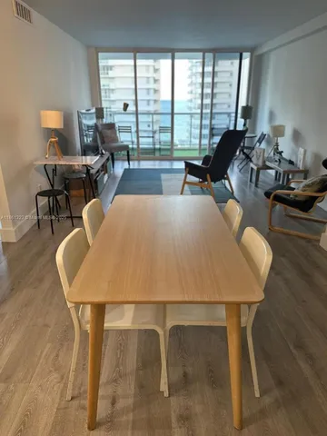 a view of a kitchen with refrigerator and a stove