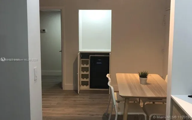 a large kitchen with stainless steel appliances granite countertop a refrigerator and a sink