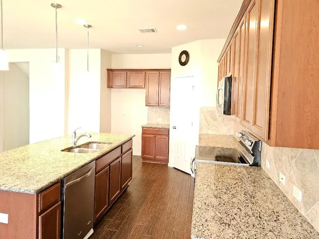 a spacious bathroom with a granite countertop sink and a large mirror