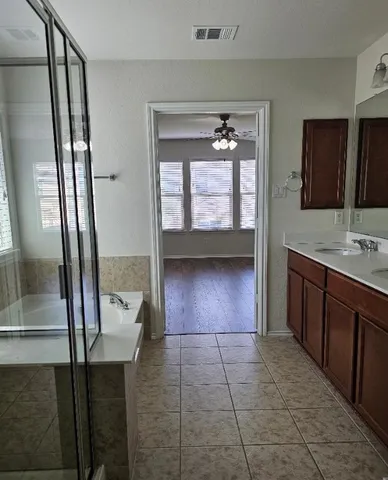 a bathroom with a vanity mirror and bathtub