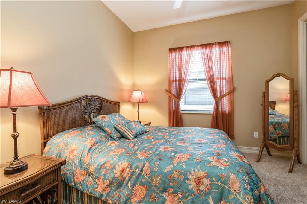 1411 Serrano Circle Naples, FL 34105 - Photo 34 of 50 Bedroom with carpet, vaulted ceiling, and ceiling fan