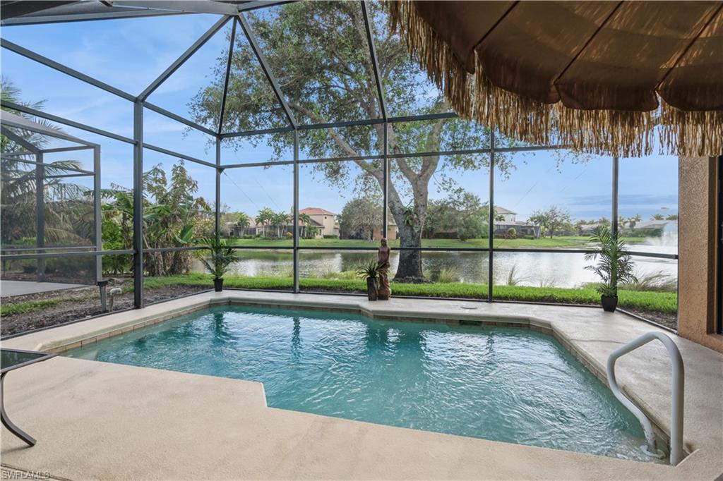 1411 Serrano Circle Naples, FL 34105 - Photo 37 of 50 View of swimming pool featuring glass enclosure, a water view, and a patio