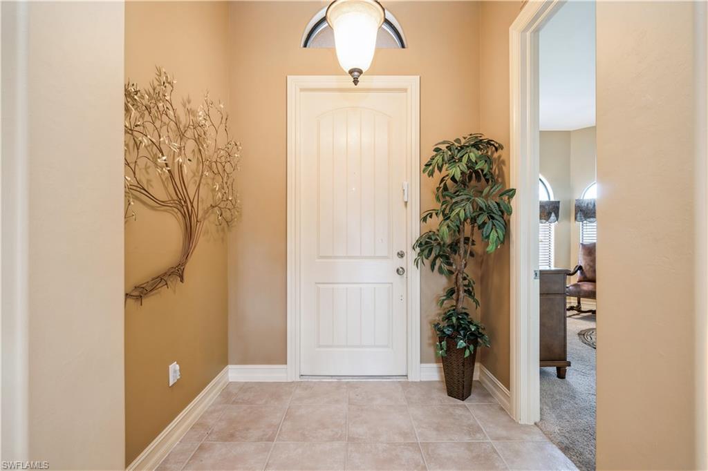 1411 Serrano Circle Naples, FL 34105 - Photo 8 of 50 Entryway with light tile patterned floors