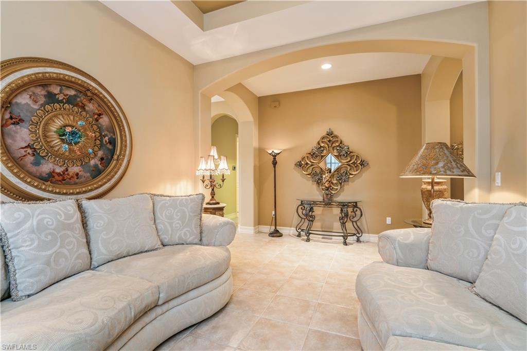 1411 Serrano Circle Naples, FL 34105 - Photo 10 of 50 Living room with light tile patterned flooring and a chandelier