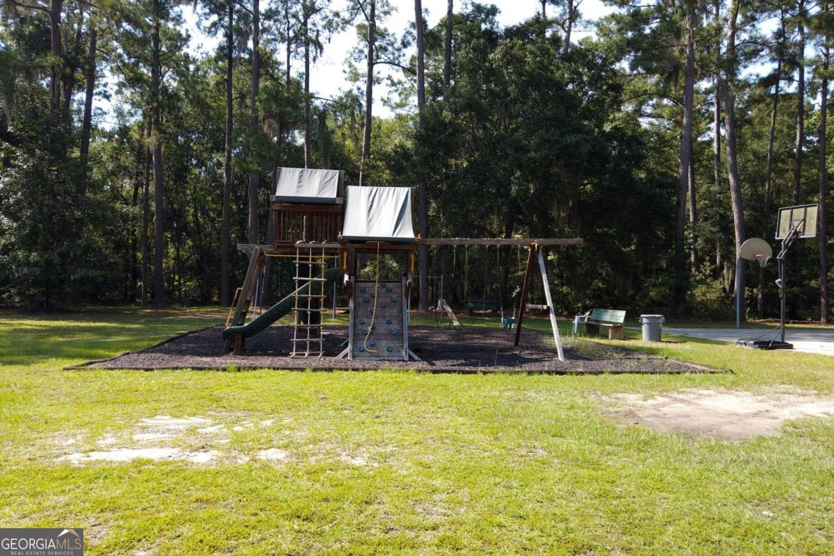 2061 Belle Island Road Richmond Hill, GA 31324 - Photo 46 of 49 a view of a swimming pool with a house and large trees
