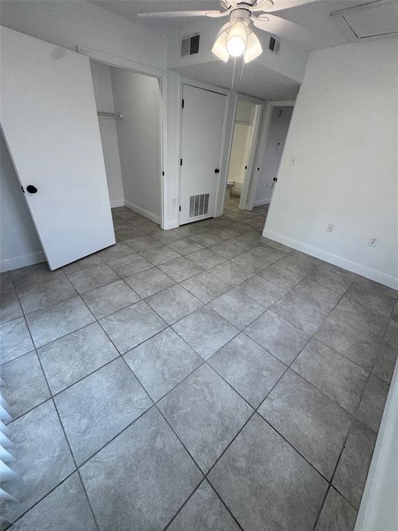 1195 Bentley Road, Unit 1 Leesburg, FL 34748 - Photo 13 of 13 an empty room with a ceiling fan and carpet