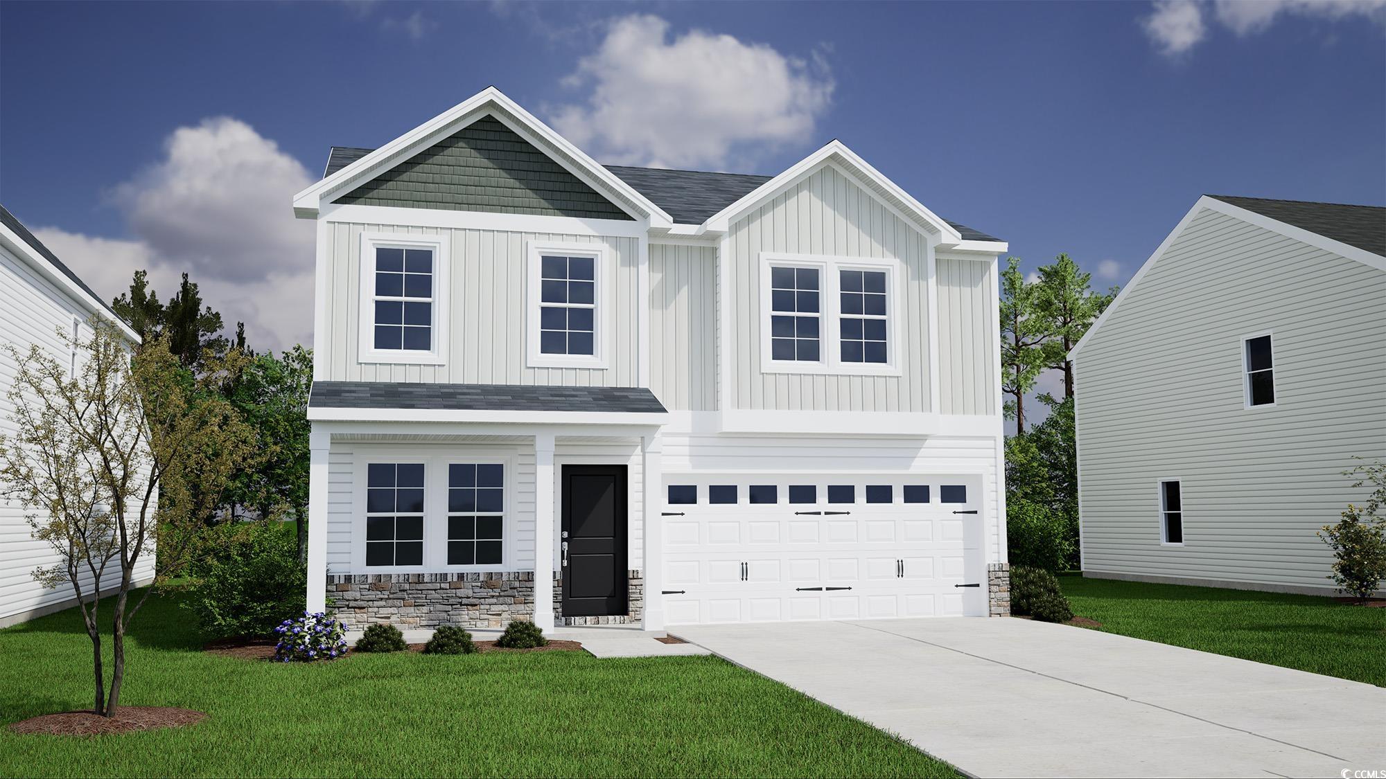 View of front of property featuring board and batten siding, stone siding, an attached garage, and a front yard