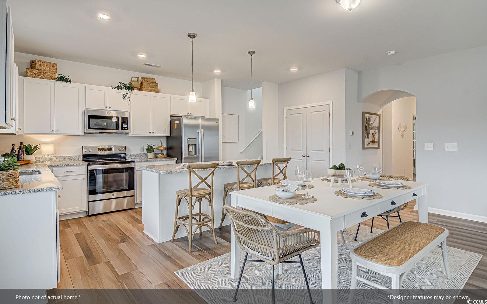 312 Garden Grove Street Conway, SC 29526 - Photo 2 of 8 Kitchen with appliances with stainless steel finishes, a center island, hanging light fixtures, white cabinets, and recessed lighting