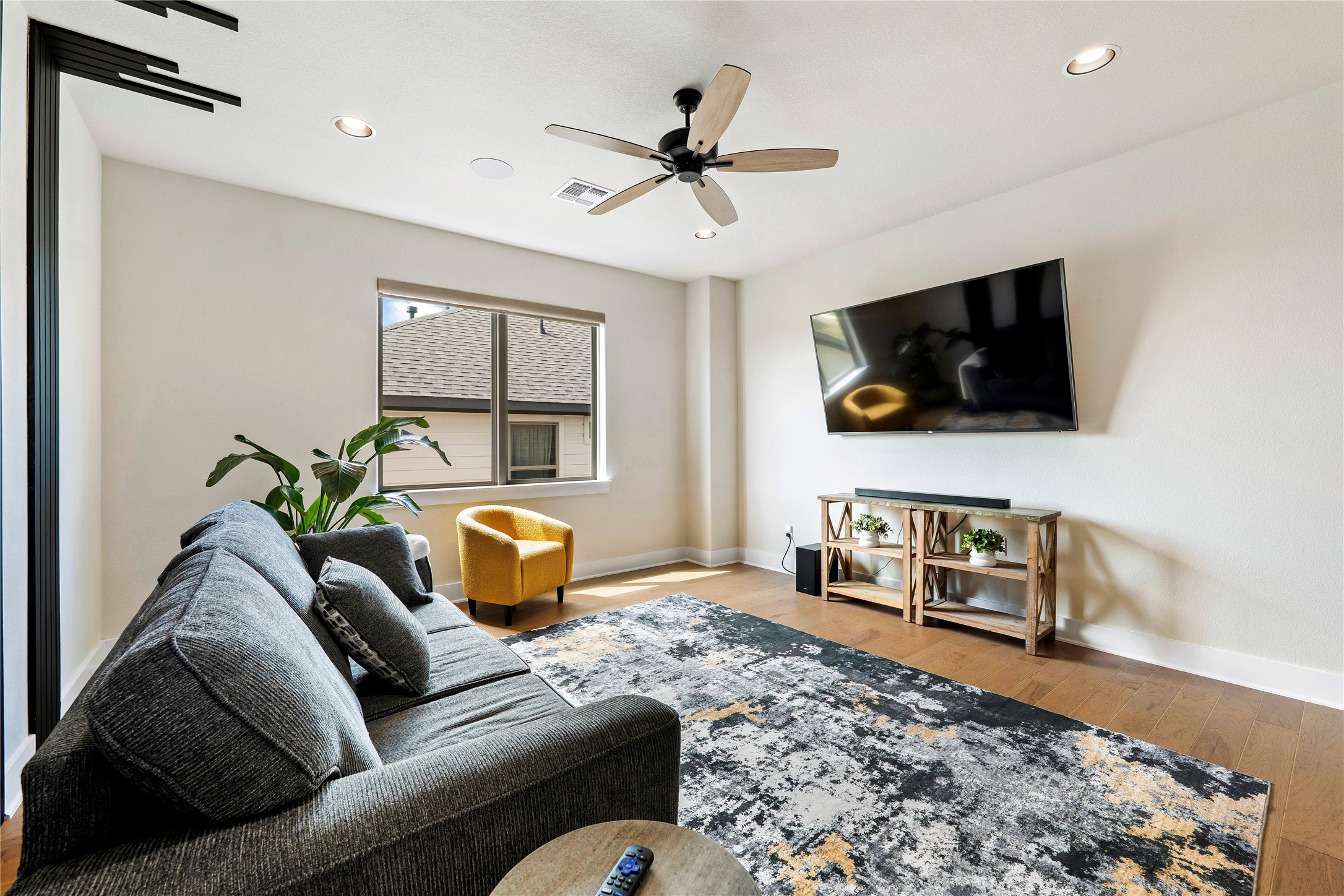 2408 Nate's Place Georgetown, TX 78633 - Photo 23 of 40 Hardwood floors and recessed lighting frame this inviting living room.