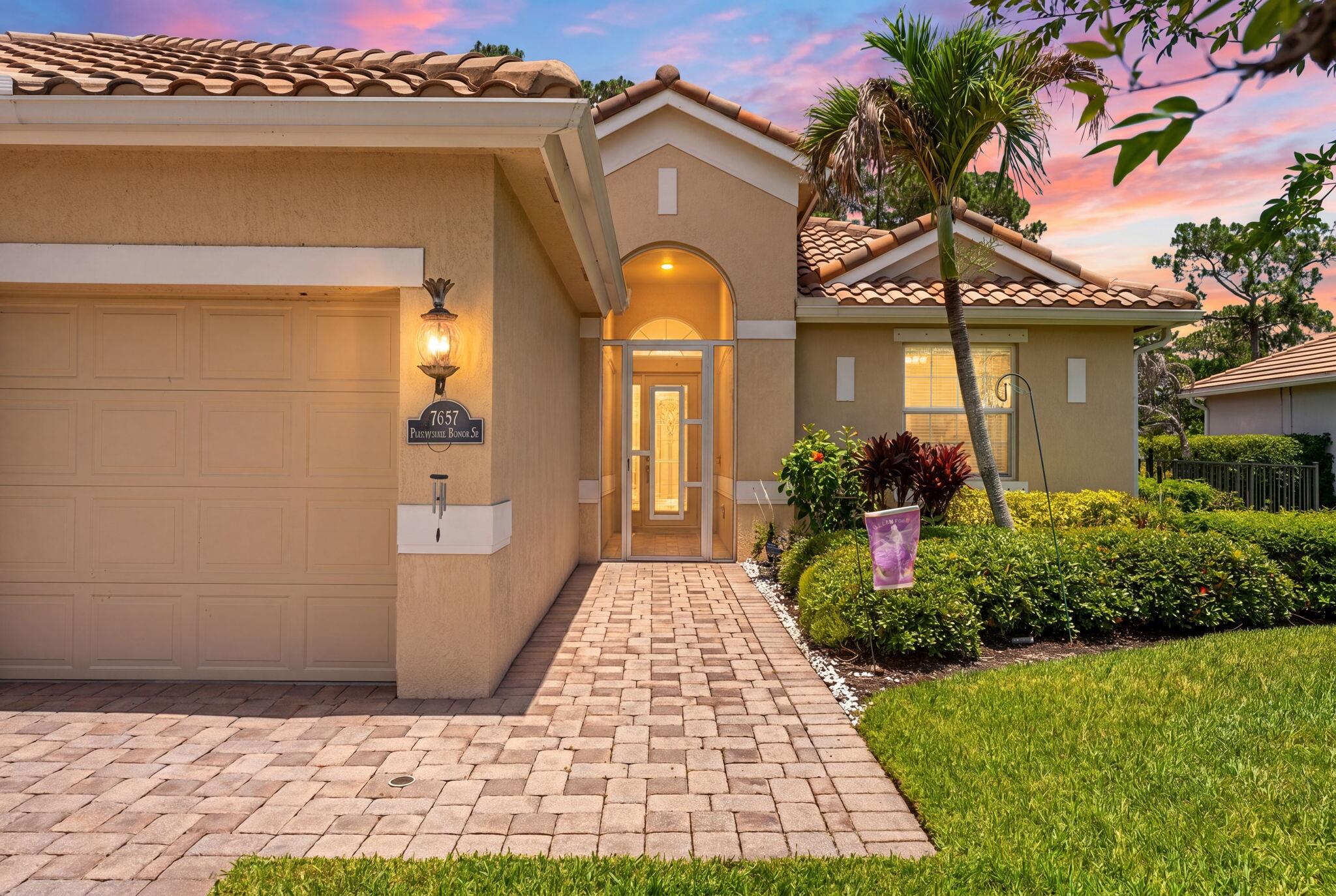 7657 Fieldstone Ranch Square Vero Beach, FL 32967 - Photo 2 of 52 a front view of a house with a garden