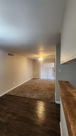 a view of a room with wooden floor