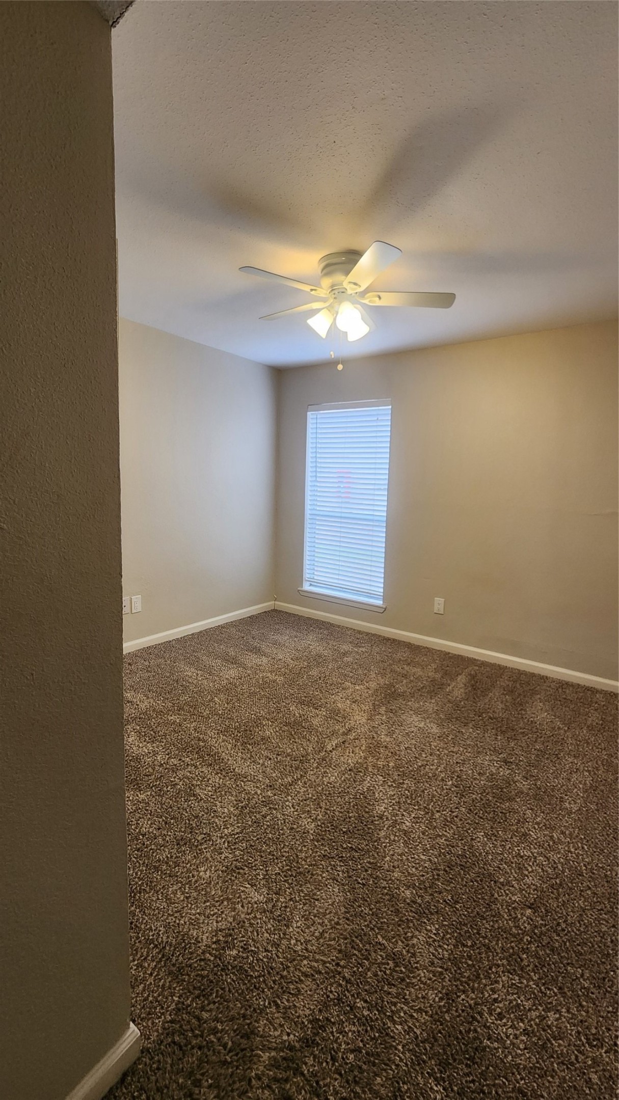 16303 Lyons School Road, Unit 701 Spring, TX 77379 - Photo 8 of 9 an empty room with windows and fan