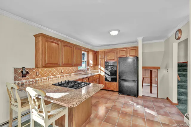 a kitchen with granite countertop a sink cabinets and window