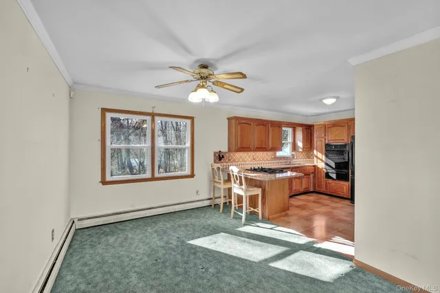 a view of an empty room with a kitchen