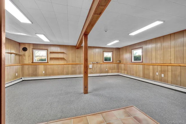 a spacious bathroom with a large window and a bath tub