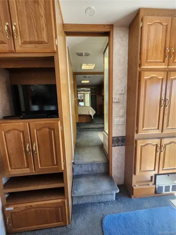 a kitchen with granite countertop a stove and a microwave