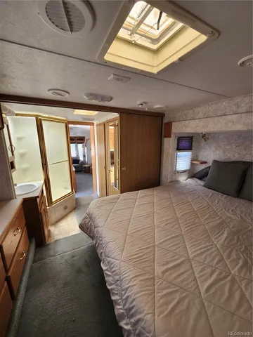 a bathroom with a toilet and a mirror