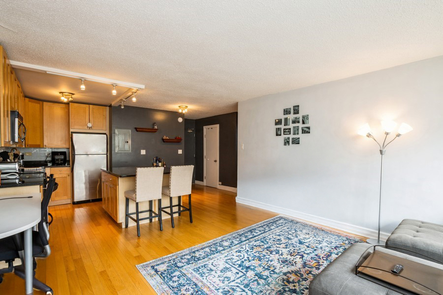 2930 North Sheridan Road, Unit 1008 Chicago, IL 60657 - Photo 3 of 12 a living room with furniture and wooden floor