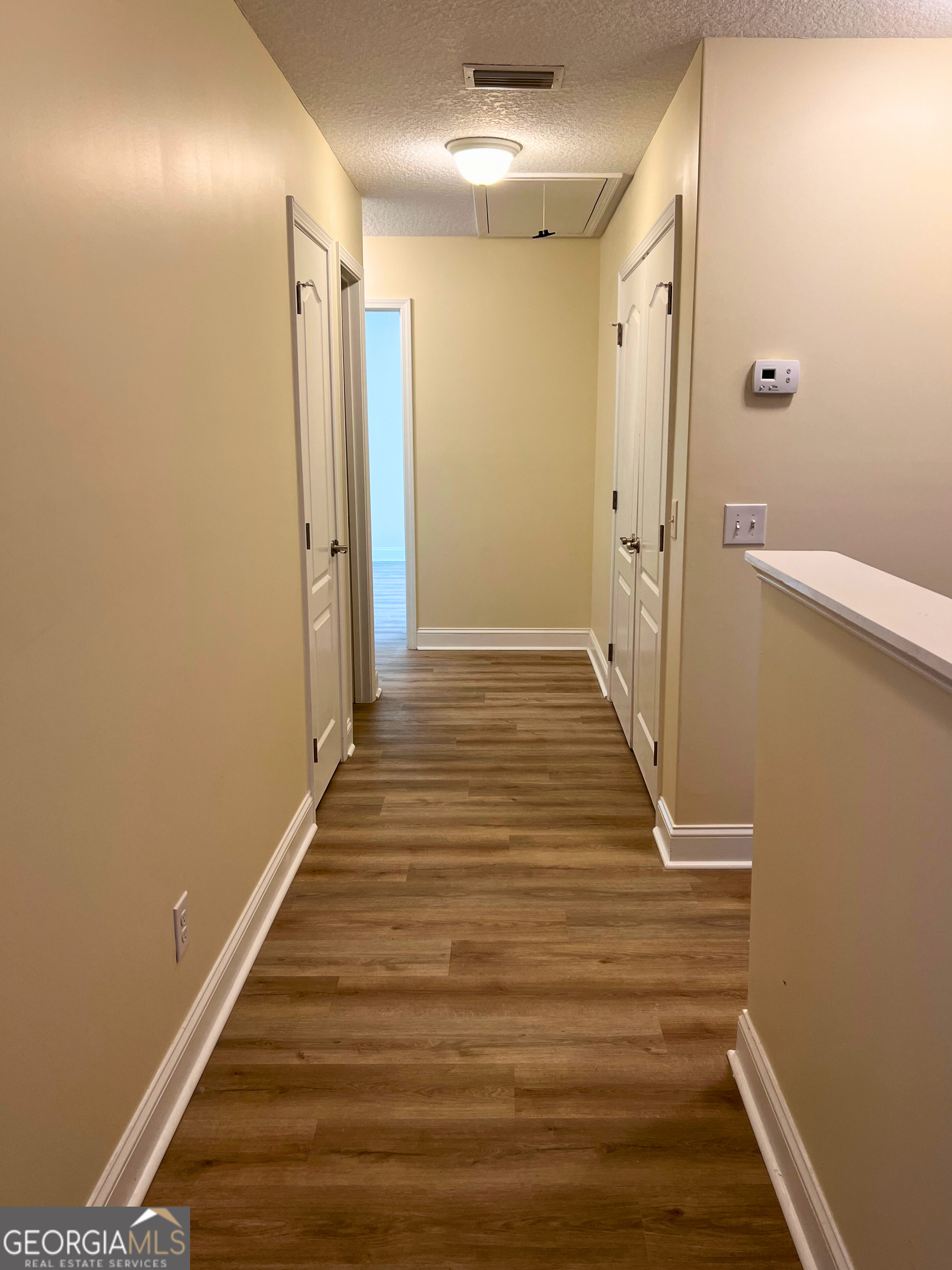 818 Davis Avenue Kingsland, GA 31548 - Photo 11 of 29 a view of a hallway with wooden floor and staircase