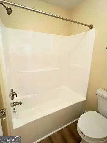 a bathroom with a shower and a toilet