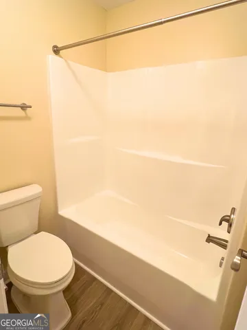 a bathroom with a toilet and a shower