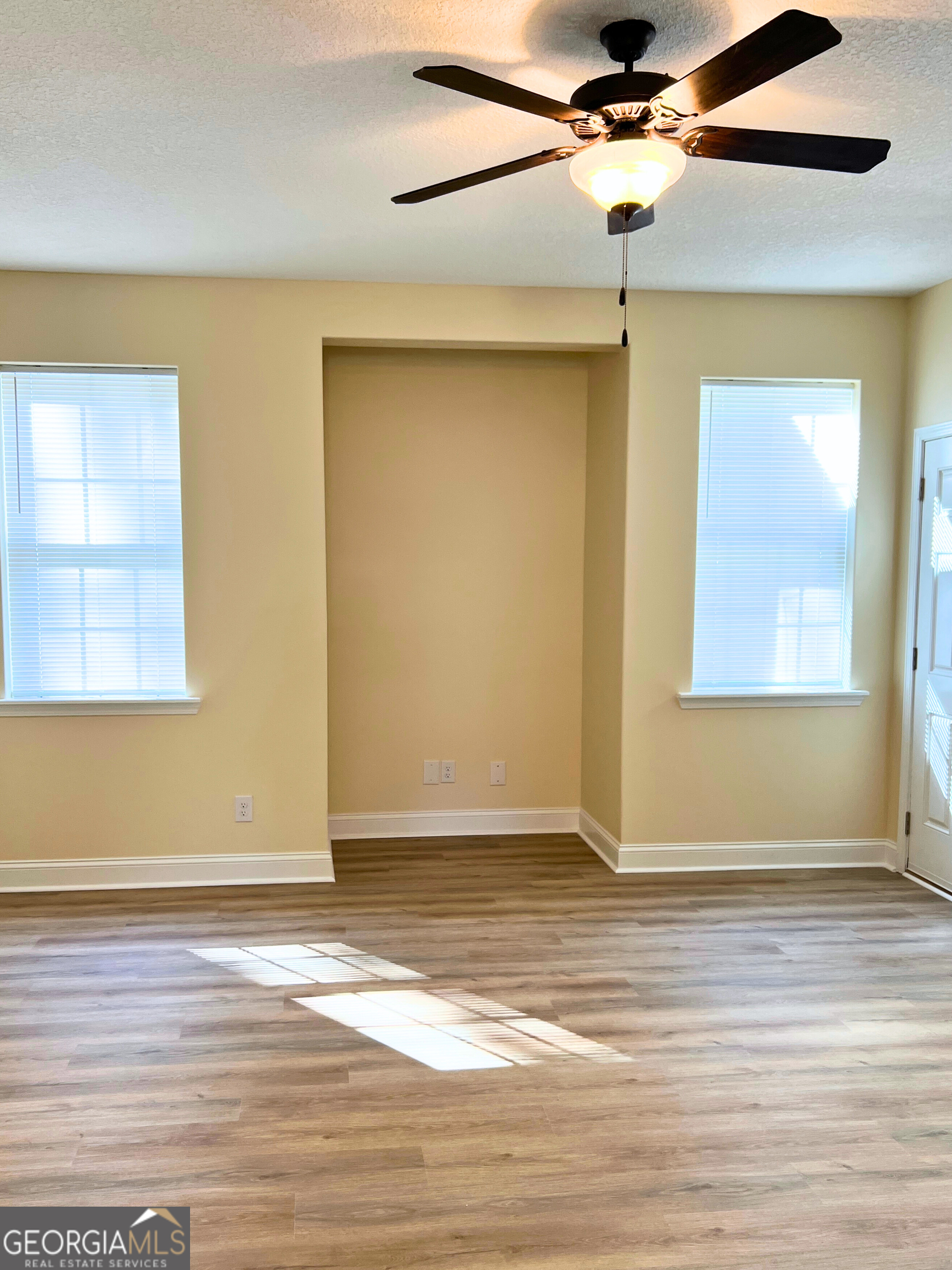 818 Davis Avenue Kingsland, GA 31548 - Photo 5 of 29 a view of an empty room with wooden floor and a window
