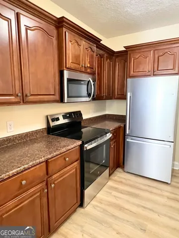 a kitchen with a refrigerator stove and microwave