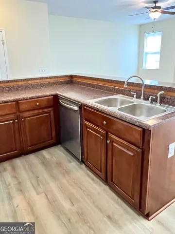 a kitchen with stainless steel appliances granite countertop a sink and cabinets