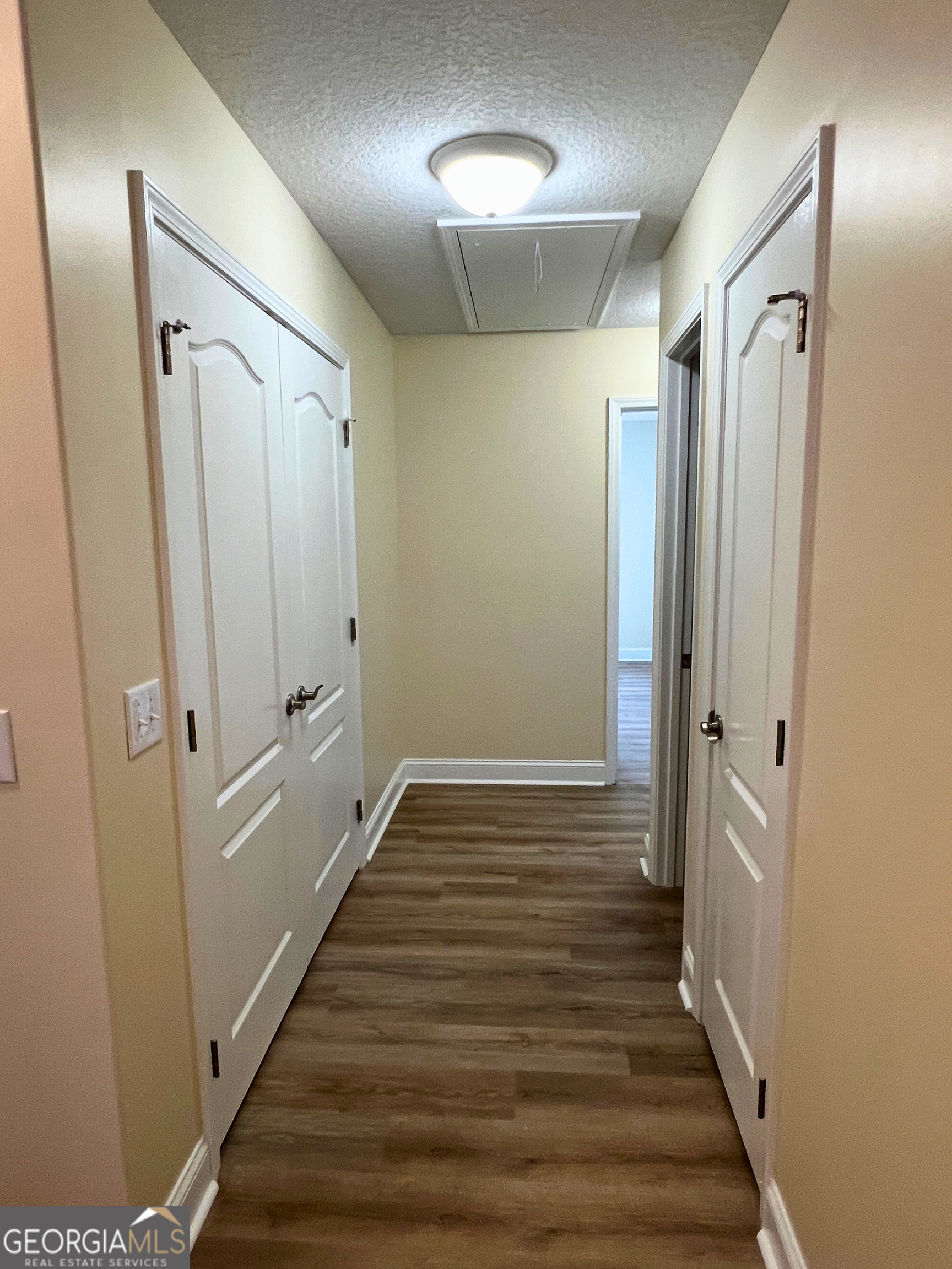 818 Davis Avenue Kingsland, GA 31548 - Photo 10 of 29 a view of a hallway with wooden floor and staircase