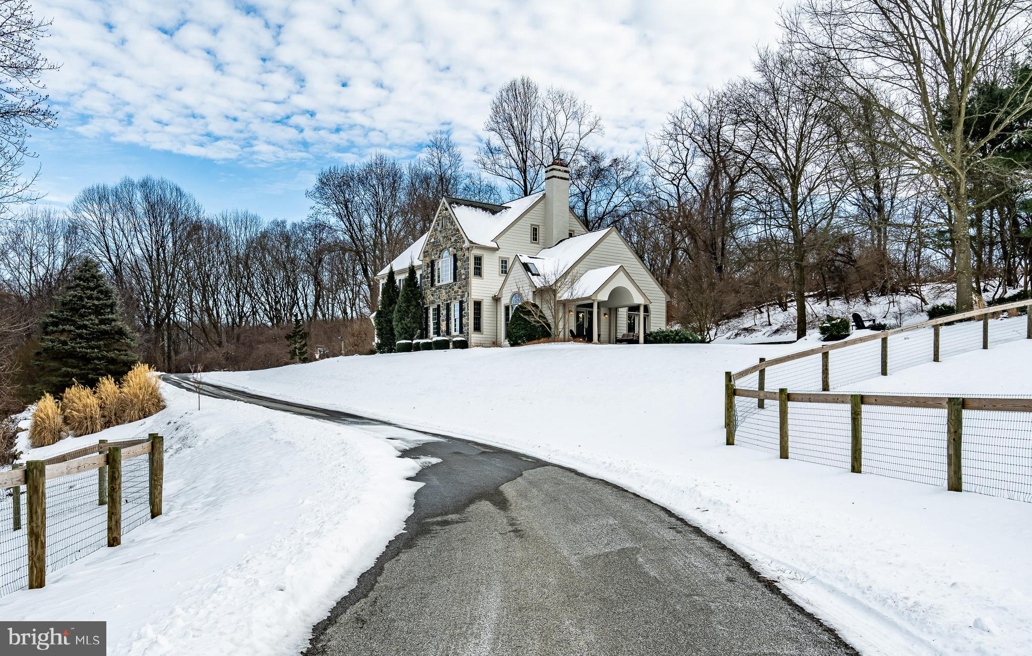 a view of a house with snow on the road