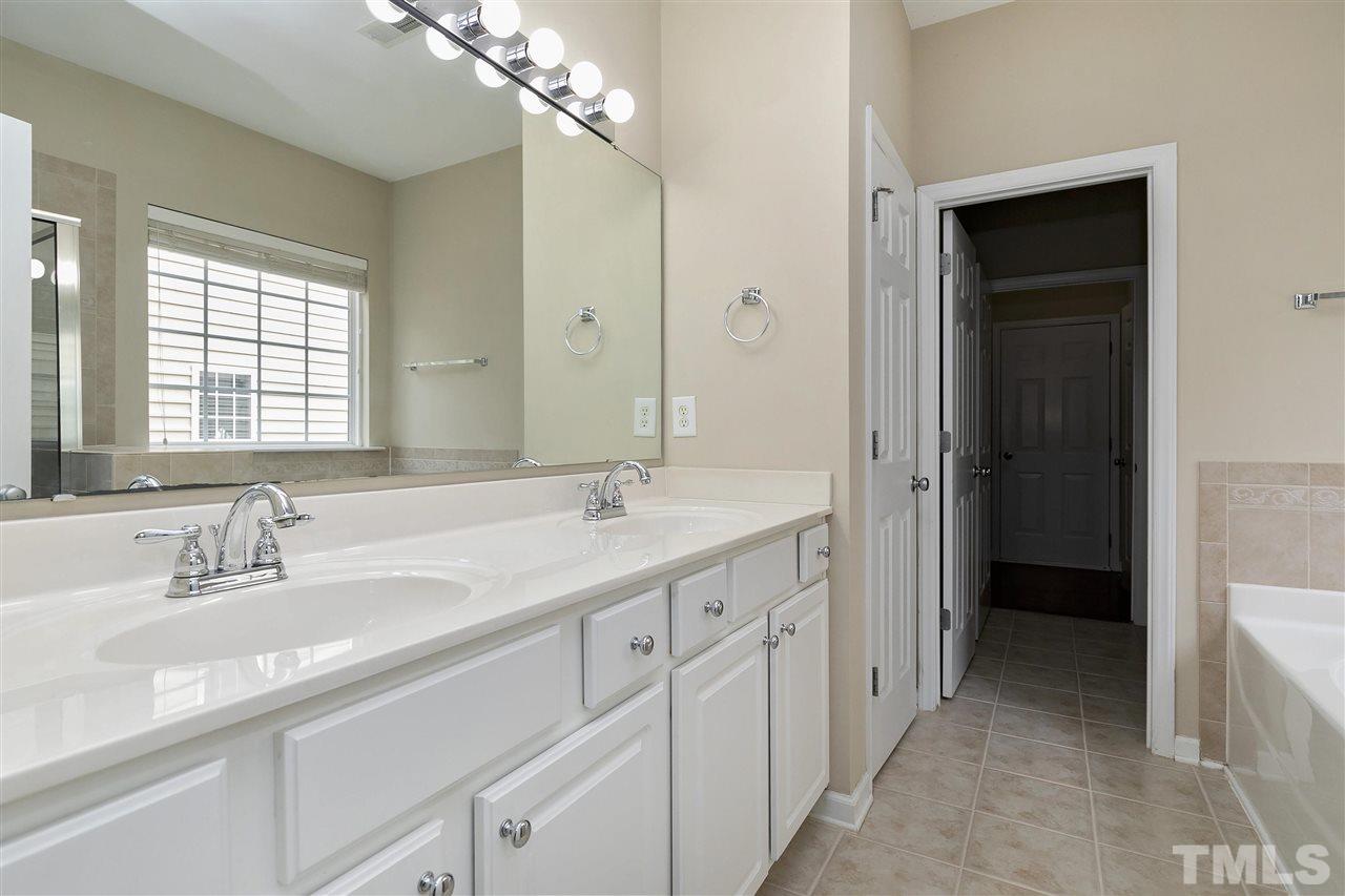 8424 Aztec Dawn Court Raleigh, NC 27613 - Photo 14 of 30 a bathroom with a sink double vanity and a mirror