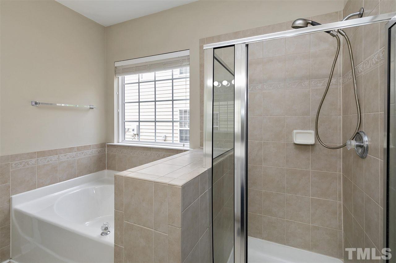8424 Aztec Dawn Court Raleigh, NC 27613 - Photo 16 of 30 a bathroom with a bathtub and a shower