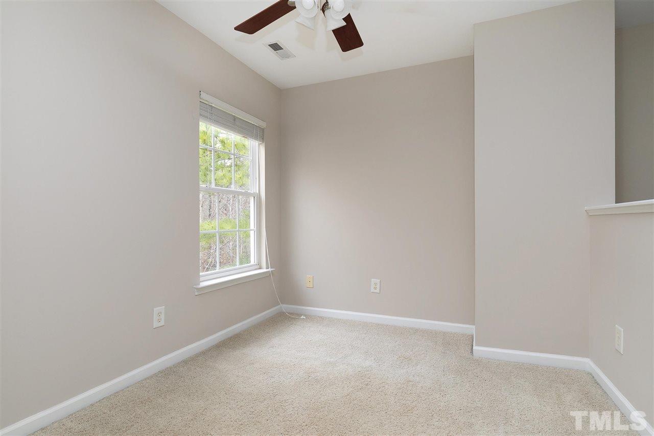 8424 Aztec Dawn Court Raleigh, NC 27613 - Photo 20 of 30 an empty room with a window and a fan