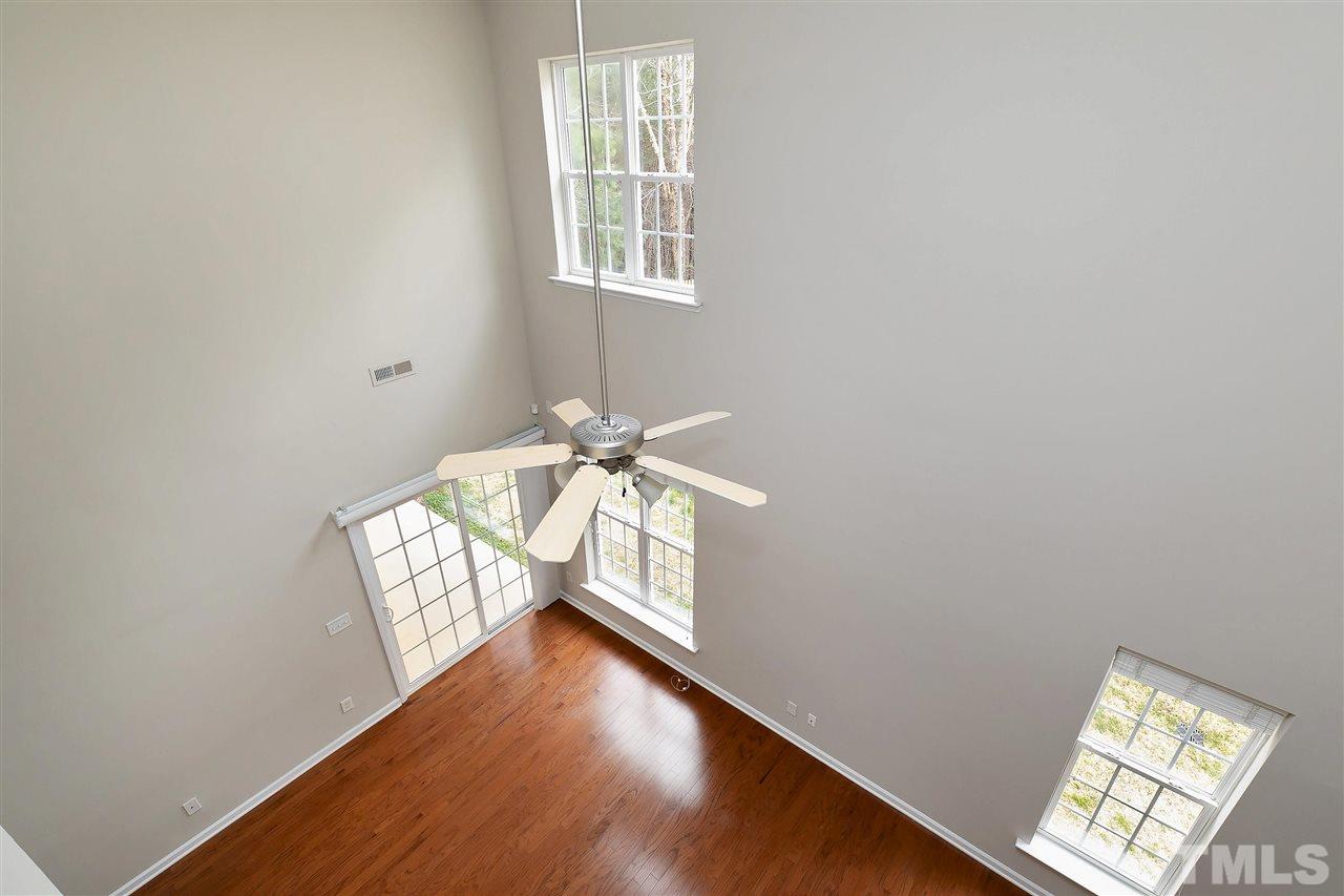 8424 Aztec Dawn Court Raleigh, NC 27613 - Photo 21 of 30 a view of an empty room with wooden floor and a window