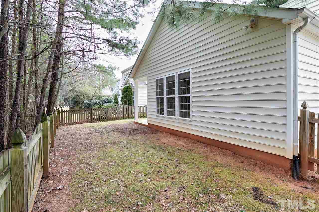 8424 Aztec Dawn Court Raleigh, NC 27613 - Photo 26 of 30 a view of a backyard with a large tree