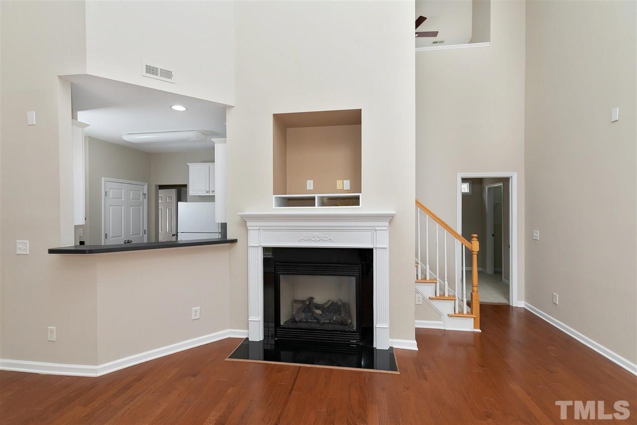 8424 Aztec Dawn Court Raleigh, NC 27613 - Photo 4 of 30 a living room with furniture and a fireplace