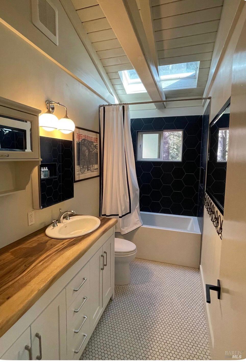 28800 Seaview Road Cazadero, CA 95421 - Photo 9 of 14 a bathroom with a granite countertop sink toilet and shower