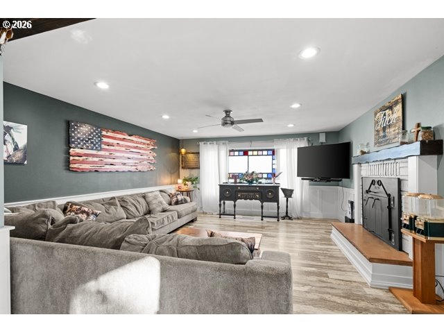 526 East Punkin Center Road Hermiston, OR 97838 - Photo 5 of 48 a living room with furniture a flat screen tv and a fireplace