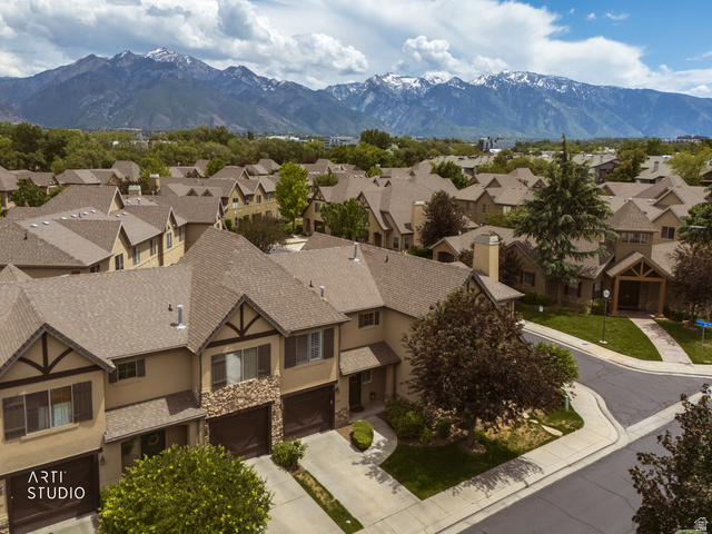 6761 950 East Midvale, UT 84047 - Photo 34 of 44 Aerial perspective showcasing a residential community with snow-capped mountain scenery