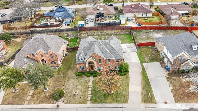 an aerial view of residential houses with outdoor space and swimming pool