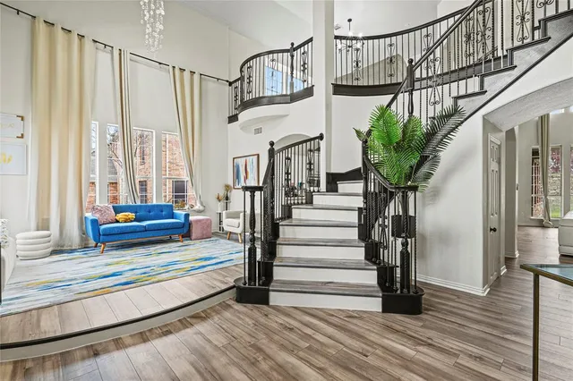 a view of staircase with wooden floor and a potted plant