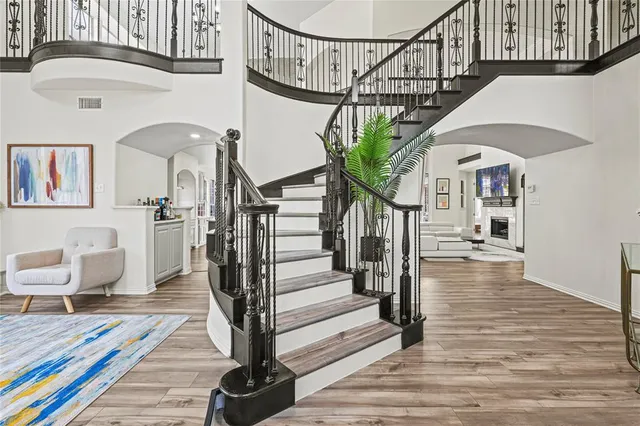 a view of entryway livingroom and hall with wooden floor
