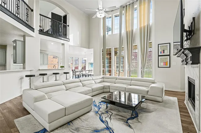 a living room with furniture fireplace and a window