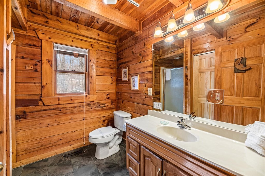 4130 Evans Chapel Road Sevierville, TN 37876 - Photo 6 of 33 a bathroom with a granite countertop sink toilet a mirror and shower