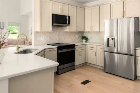 a kitchen with a sink appliances and cabinets